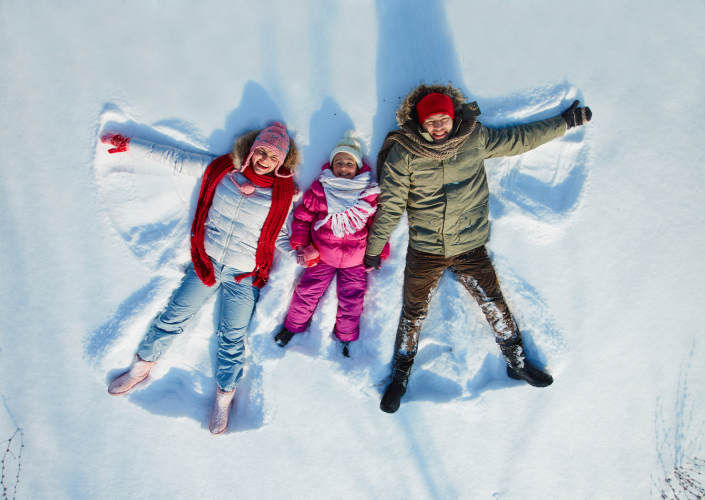 family making snow angels